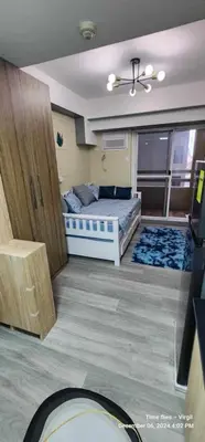 a room with a bedroom with a bed and a window at Propitious Place at Sta Mesa in Manila