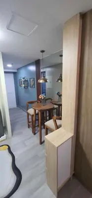 a living room with a table and a dining room at Propitious Place at Sta Mesa in Manila