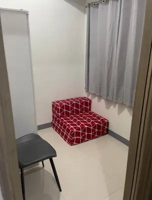 a chair and a red box in a room at S Residences MOA complex in Manila
