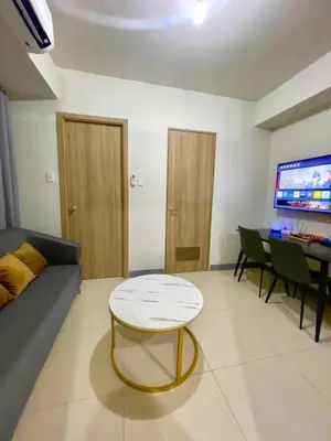 a living room with a couch and a table at S Residences MOA complex in Manila