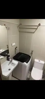 a bathroom with a white toilet and a sink at S Residences MOA complex in Manila