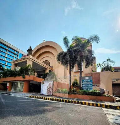 a building with a palm tree in front of it at Gallardo Condo Stays at Eighty One Newport Boulevard Newport City, Pasay City near NAIA Terminal 3 in Manila