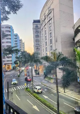 a city street with cars and palm trees and buildings at Gallardo Condo Stays at Eighty One Newport Boulevard Newport City, Pasay City near NAIA Terminal 3 in Manila