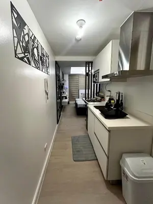 a kitchen with a sink and a counter top at SM Bicutan Getaway in Manila