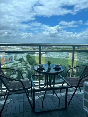 a table and chairs on a balcony with a view at SM Bicutan Getaway in Manila
