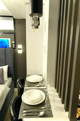 a table with plates and wine glasses on it at SM Bicutan Getaway in Manila