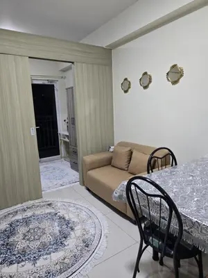 a living room with a couch and a table at Rhoydez Condotel Breeze Residence in Manila