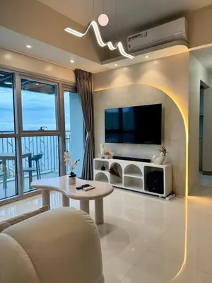 a living room with a table and a tv at Panoramic Landscape Seaview, 2BR, near Airport, 11m in Manila