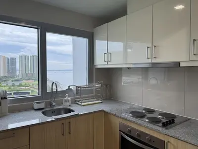 a kitchen with white cabinets and a sink and a window at Panoramic Landscape Seaview, 2BR, near Airport, 11m in Manila