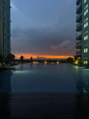 a large pool of water with a sunset in the background at Panoramic Landscape Seaview, 2BR, near Airport, 11m in Manila