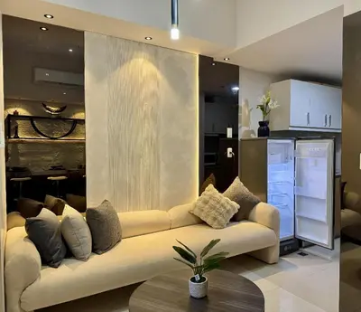 a living room with a couch with pillows on it at Stylish 1br inside BGC at Uptown Parksuites - 24k in Manila