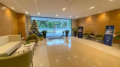 a living room with a christmas tree in a lobby at Leaf residences condotel 2bedroom Muntinlupa in Manila