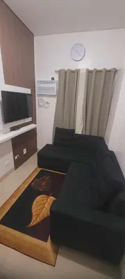 a living room with a bed and a tv at Leaf residences condotel 2bedroom Muntinlupa in Manila