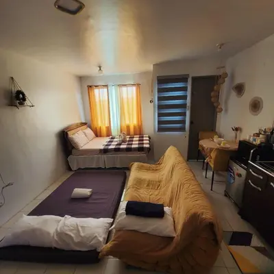 a living room with two beds and a kitchen at DJ's Staycation in Santa Rosa