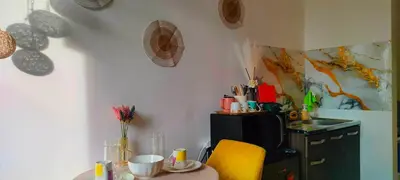 a kitchen with a table and a yellow chair at DJ's Staycation in Santa Rosa