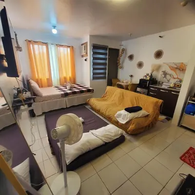 a room with two beds in it with a kitchen at DJ's Staycation in Santa Rosa