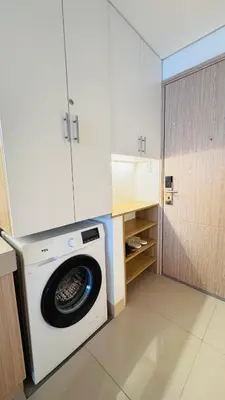 a washing machine in a kitchen next to a cabinet at Student Hub at DLSU in Pasong Bayog
