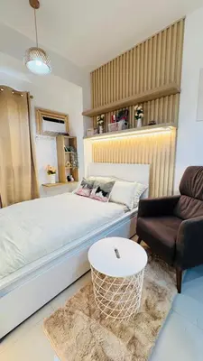 a bedroom with a white bed and a couch at Student Hub at DLSU in Pasong Bayog