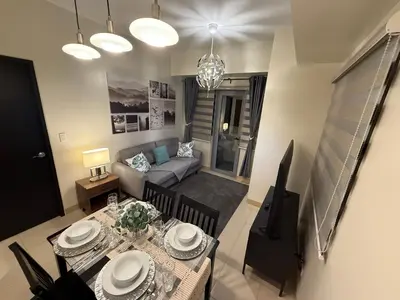 a living room with a table and a couch at HAVEN on the 28th in Manila