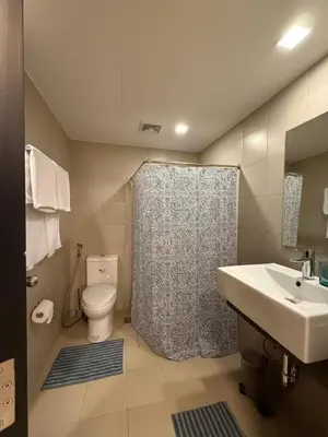 a bathroom with a toilet and a sink and a shower at HAVEN on the 28th in Manila