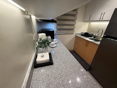 a small kitchen with a counter with a sink at HAVEN on the 28th in Manila