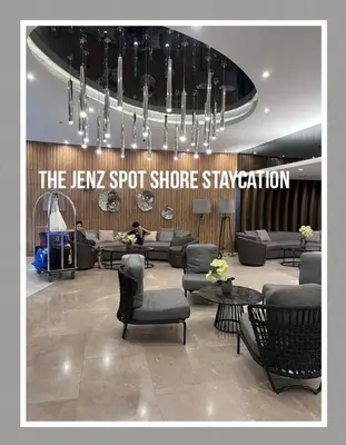 a lobby with couches and chairs and a sign at The Jenz Spot Shore Staycation in Manila