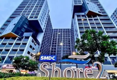 a sharma sign in front of some tall buildings at The Jenz Spot Shore Staycation in Manila