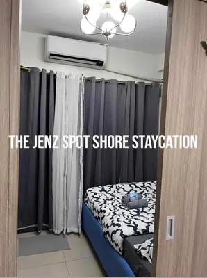 a small room with a bed and a window at The Jenz Spot Shore Staycation in Manila