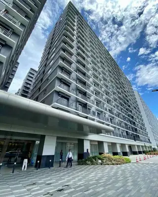 a large building with people walking in front of it at comfy 1 bedroom family condo in Manila