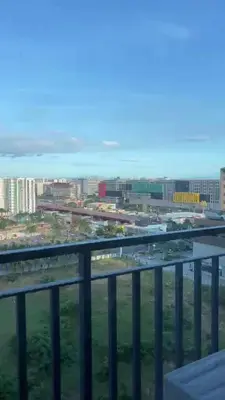 a view of a city from a balcony at comfy 1 bedroom family condo in Manila