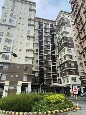 a large apartment building with a street sign in front of it at Modern Studio Condominium 2 in Manila