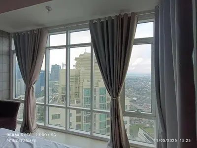 a large window with curtains in a room at 1 Bedroom Red Oak Serendra BGC in Manila