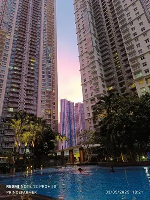 a swimming pool in a city with tall buildings at 1 Bedroom Red Oak Serendra BGC in Manila