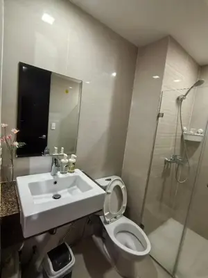 a bathroom with a sink and a toilet and a shower at Classy Condotel Across NAIA Terminal 3 in Manila