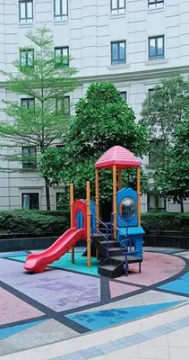 a playground with a slide in front of a building at Classy Condotel Across NAIA Terminal 3 in Manila