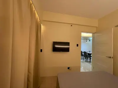 a bedroom with a bed and a dining room at Pinecrest residential resort in Manila