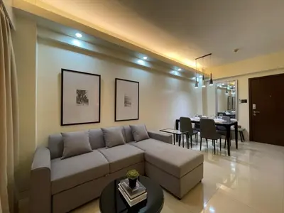 a living room with a couch and a dining room at Pinecrest residential resort in Manila