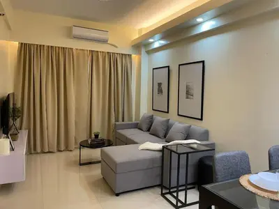 a living room with a couch and a table at Pinecrest residential resort in Manila