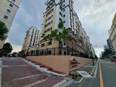a tall building with a tree on the side of it at Pinecrest residential resort in Manila