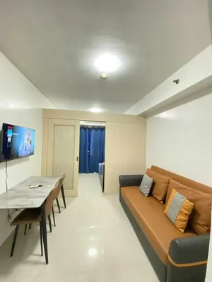 a living room with a couch and a table at Ailyn staycation in Manila