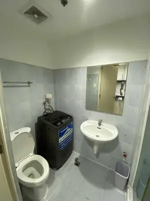 a bathroom with a toilet and a sink at Ailyn staycation in Manila