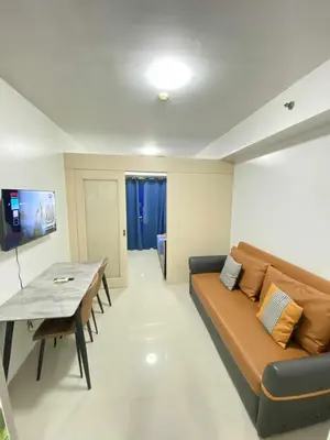 a living room with a couch and a table at Ailyn staycation in Manila