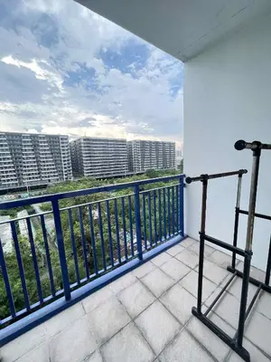 a balcony with a view of the water and buildings at Ailyn staycation in Manila