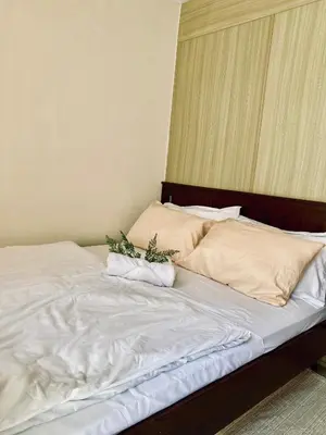 a bed with two plants on top of it at Shore Escape PH in Manila