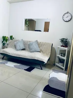 a bed in a room with mats on the floor at Shore Escape PH in Manila