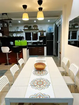 a kitchen and dining room with a table and chairs at C&G Staycation Home in General Trias