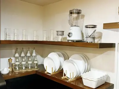 a kitchen with plates and glasses on a shelf at C&G Staycation Home in General Trias
