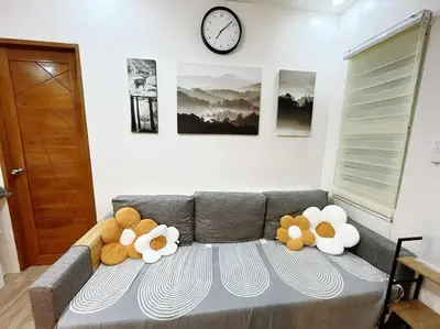 two stuffed teddy bears sitting on top of a couch at C&G Staycation Home in General Trias