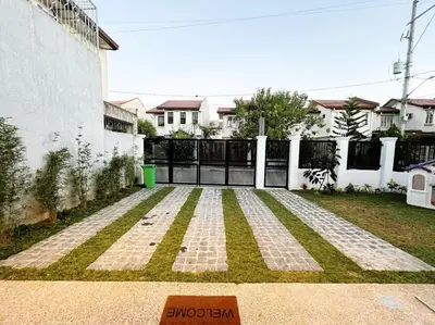 a yard with a fence and a gate with grass at C&G Staycation Home in General Trias