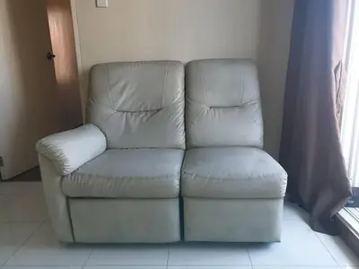 a white chair sitting next to a window at Peaceful City View Condo for Rent in Quezon City in Manila